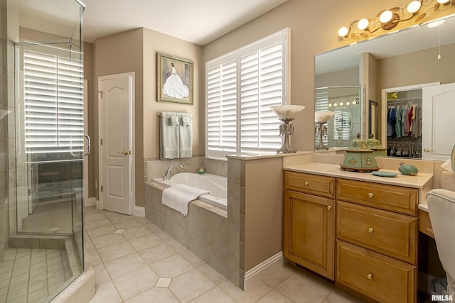 1302 Collins Ln, Marion, IL 62959 - full bath featuring a garden tub, a stall shower, tile patterned flooring, and a spacious closet