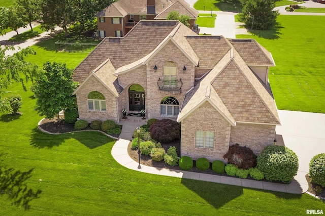 1302 Collins Ln, Marion, IL 62959 - view of front of house featuring brick siding, a front yard, a balcony, and a shingled roof