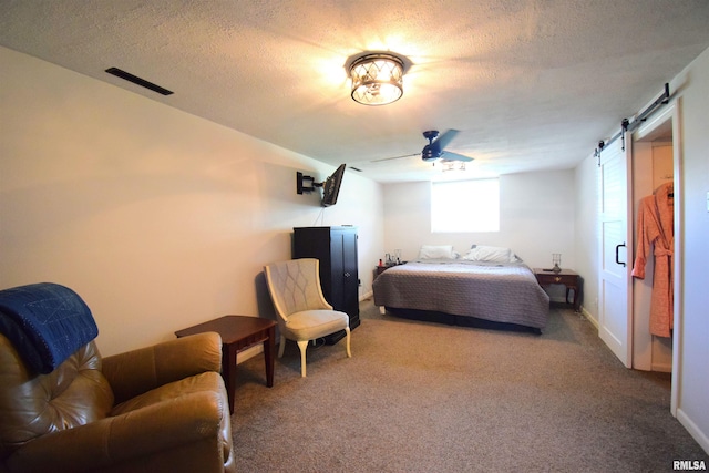 3100 Mulberry Ave, Mount Vernon, IL 62864 - carpeted bedroom featuring a barn door, a textured ceiling, and a ceiling fan