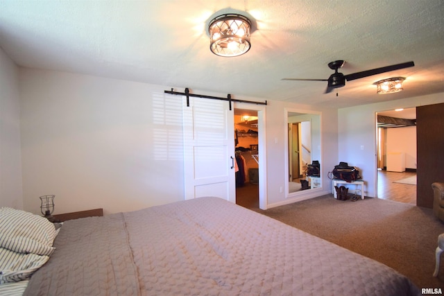 3100 Mulberry Ave, Mount Vernon, IL 62864 - carpeted bedroom with a barn door, a spacious closet, a closet, a textured ceiling, and baseboards