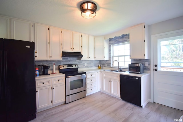 3100 Mulberry Ave, Mount Vernon, IL 62864 - kitchen with black appliances, a sink, under cabinet range hood, tasteful backsplash, and light countertops