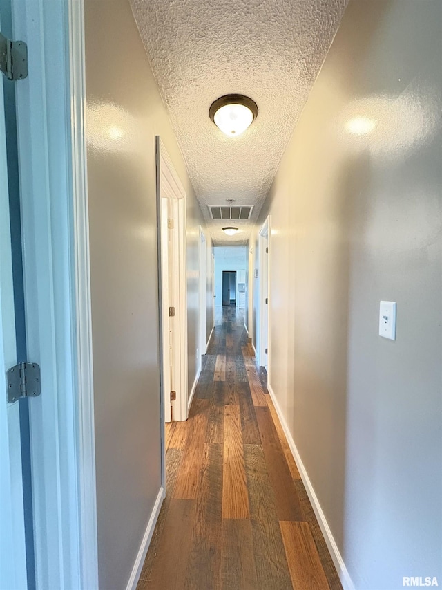 910 Fairlane Dr, Marion, IL 62959 - hallway with a textured ceiling, dark wood finished floors, and baseboards