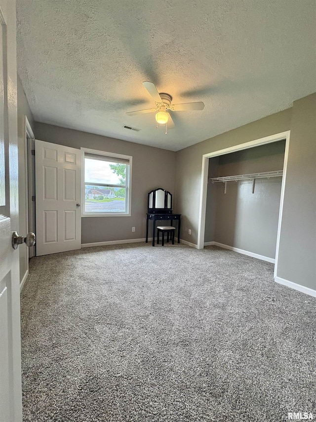 910 Fairlane Dr, Marion, IL 62959 - unfurnished bedroom featuring carpet flooring, a textured ceiling, a closet, ceiling fan, and baseboards