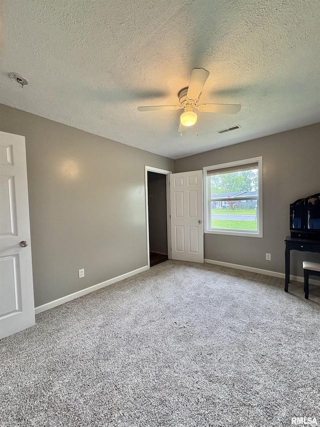 910 Fairlane Dr, Marion, IL 62959 - unfurnished bedroom featuring carpet flooring, a textured ceiling, baseboards, and ceiling fan
