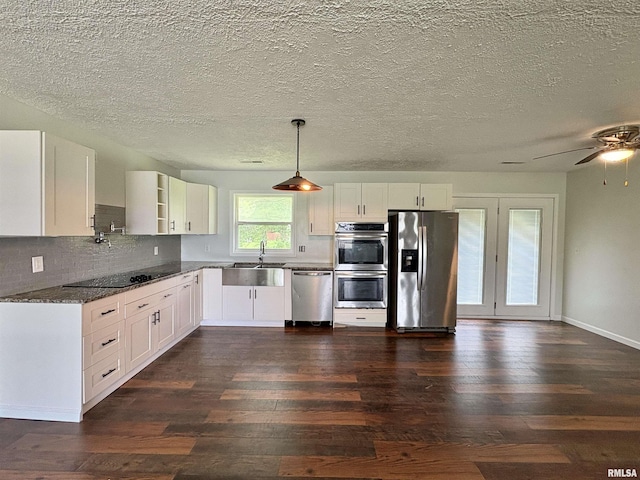 910 Fairlane Dr, Marion, IL 62959 - kitchen featuring stainless steel appliances, dark wood-type flooring, a sink, backsplash, and a textured ceiling