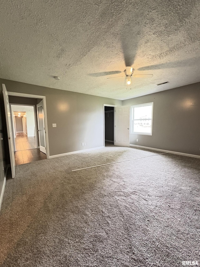 910 Fairlane Dr, Marion, IL 62959 - spare room with carpet floors, a ceiling fan, baseboards, and a textured ceiling