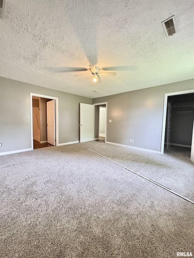 910 Fairlane Dr, Marion, IL 62959 - unfurnished bedroom with carpet floors, baseboards, ceiling fan, a closet, and a textured ceiling