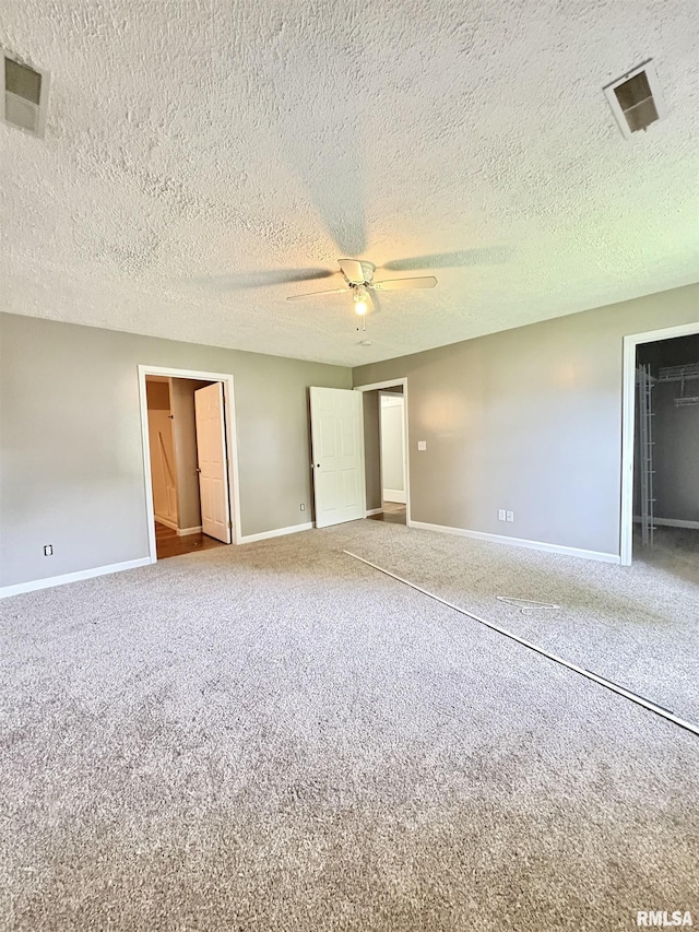 910 Fairlane Dr, Marion, IL 62959 - unfurnished bedroom with carpet flooring, baseboards, ceiling fan, a closet, and a textured ceiling
