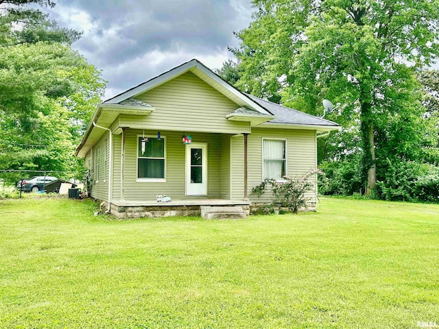 1105 N Maple St, Carterville, IL 62918 - view of front facade with covered porch, a front yard, and central air condition unit