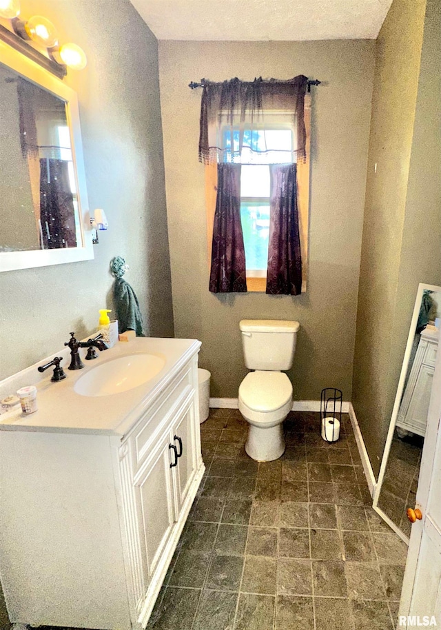 1105 N Maple St, Carterville, IL 62918 - bathroom featuring vanity, toilet, and baseboards