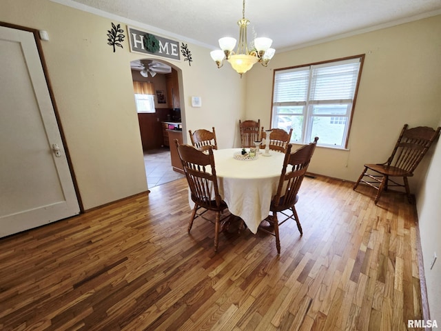 112 W Main St, Mcleansboro, IL 62859 - dining room featuring plenty of natural light, wood finished floors, crown molding, and a chandelier