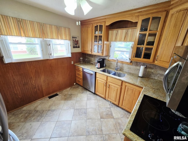 112 W Main St, Mcleansboro, IL 62859 - kitchen featuring dishwasher, a sink, wainscoting, a ceiling fan, and light stone countertops