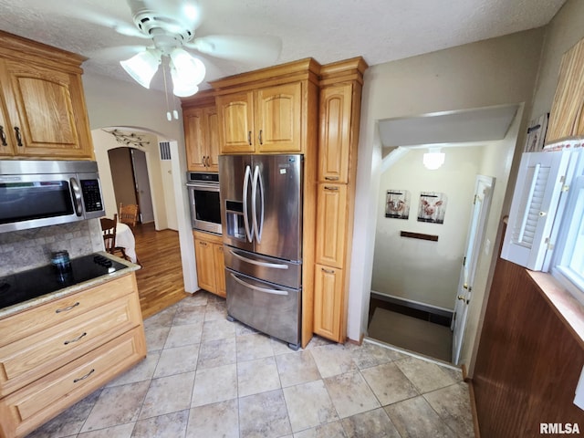 112 W Main St, Mcleansboro, IL 62859 - kitchen with appliances with stainless steel finishes, ceiling fan, arched walkways, decorative backsplash, and light tile patterned floors