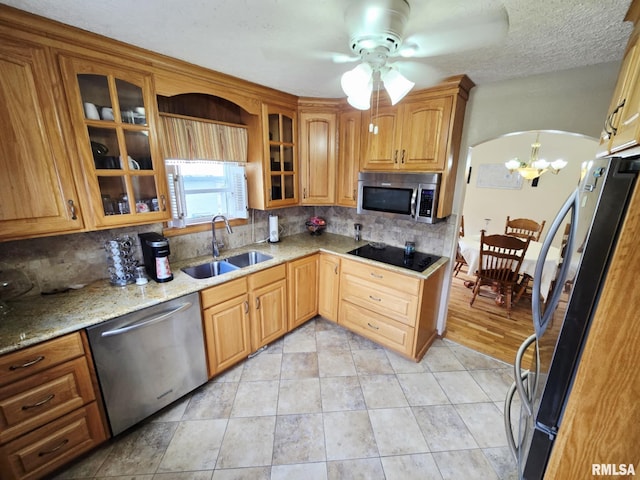 112 W Main St, Mcleansboro, IL 62859 - kitchen with appliances with stainless steel finishes, a sink, tasteful backsplash, ceiling fan, and light stone countertops