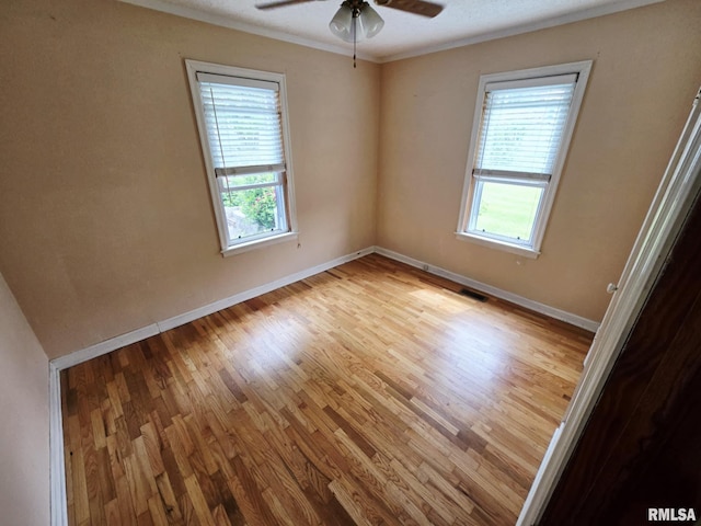 112 W Main St, Mcleansboro, IL 62859 - spare room featuring healthy amount of natural light, wood finished floors, a ceiling fan, and ornamental molding