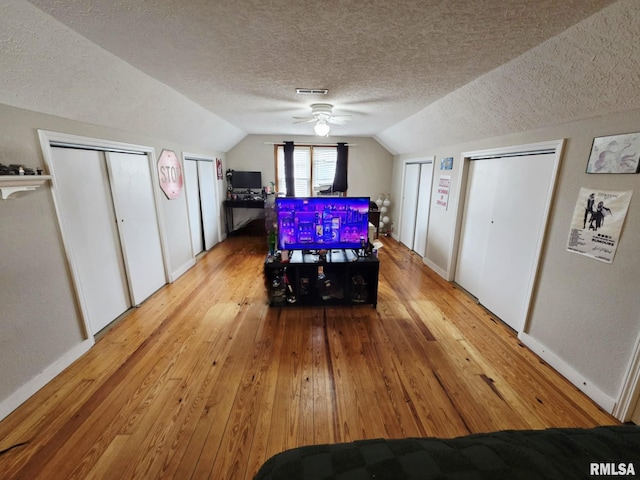 112 W Main St, Mcleansboro, IL 62859 - dining room featuring wood-type flooring, vaulted ceiling, a textured ceiling, baseboards, and ceiling fan
