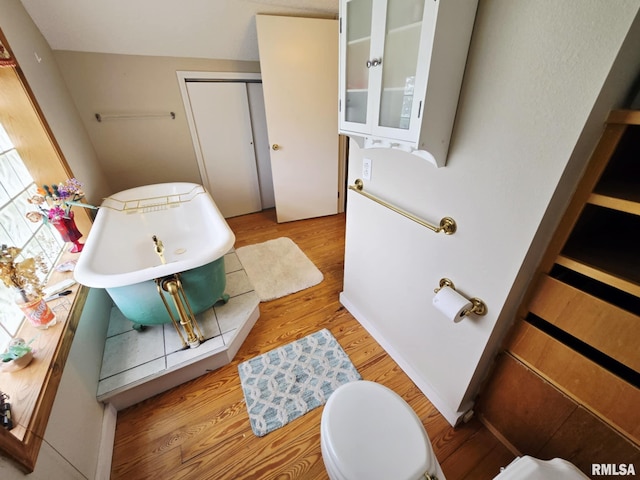 112 W Main St, Mcleansboro, IL 62859 - bathroom with wood finished floors, a freestanding bath, and toilet