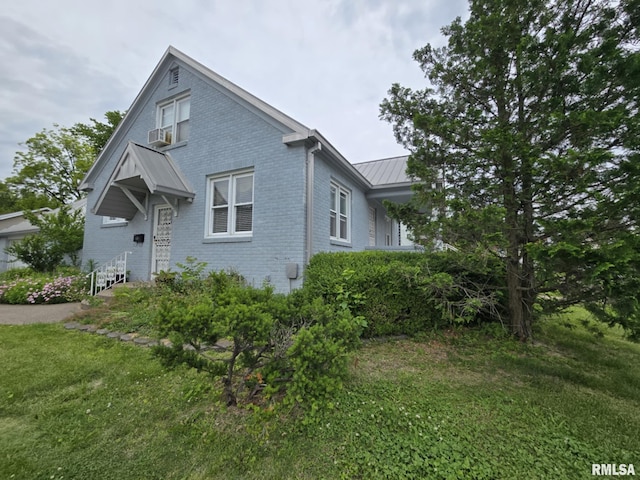 112 W Main St, Mcleansboro, IL 62859 - view of front of property with brick siding, a standing seam roof, a front lawn, metal roof, and cooling unit