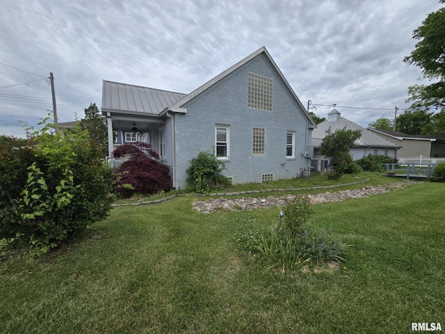 112 W Main St, Mcleansboro, IL 62859 - view of side of property featuring brick siding, a standing seam roof, metal roof, and central air condition unit