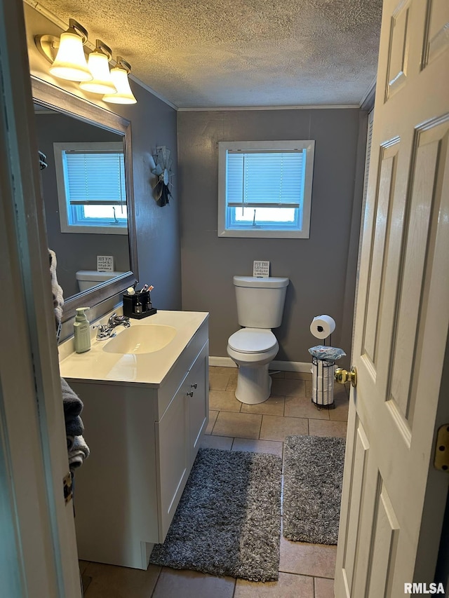 527 E Lawrence St, Benton, IL 62812 - half bath with vanity, toilet, tile patterned floors, a textured ceiling, and plenty of natural light