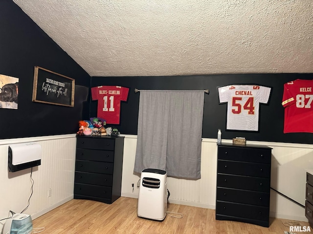 527 E Lawrence St, Benton, IL 62812 - bedroom featuring a textured ceiling, wood finished floors, a wainscoted wall, and vaulted ceiling