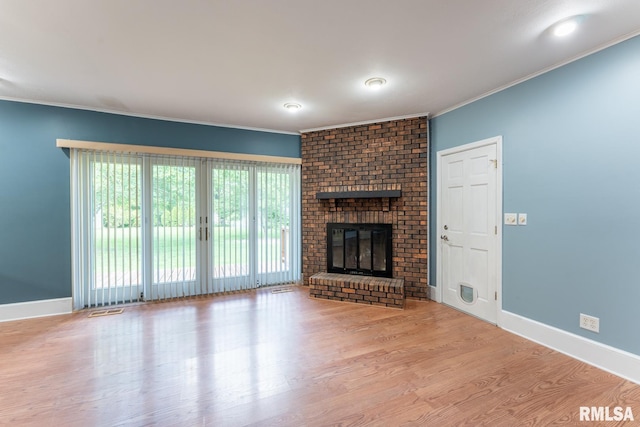 1004 Mockingbird Ln, Carterville, IL 62918 - unfurnished living room with wood finished floors, ornamental molding, baseboards, and a fireplace