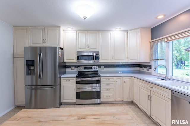 1004 Mockingbird Ln, Carterville, IL 62918 - kitchen featuring appliances with stainless steel finishes, light countertops, a sink, and baseboards