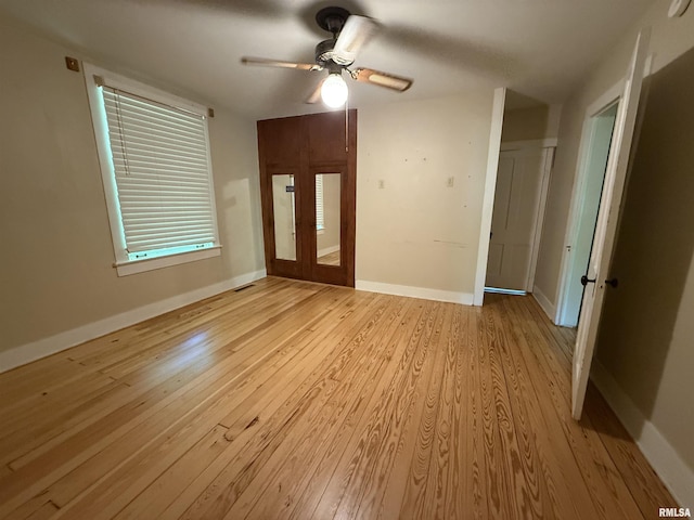 1312 W Sycamore St, Carbondale, IL 62901 - empty room with light wood-style flooring, french doors, a ceiling fan, and baseboards