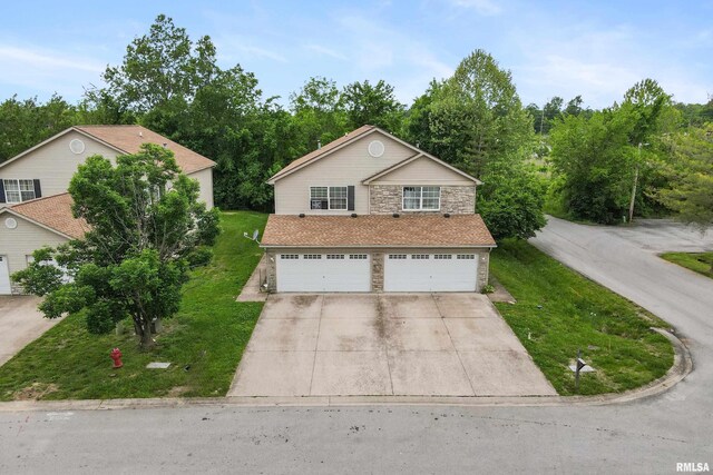 1500 Cornerstone Ct, Marion, IL 62959 - traditional home featuring stone siding, concrete driveway, a garage, and a front lawn