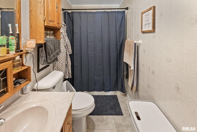 203 E 2nd St, Sparta, IL 62286 - bathroom with tile walls, tile patterned floors, ornamental molding, toilet, and vanity
