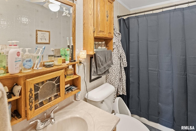 203 E 2nd St, Sparta, IL 62286 - bathroom featuring tile walls, toilet, crown molding, vanity, and a shower with curtain