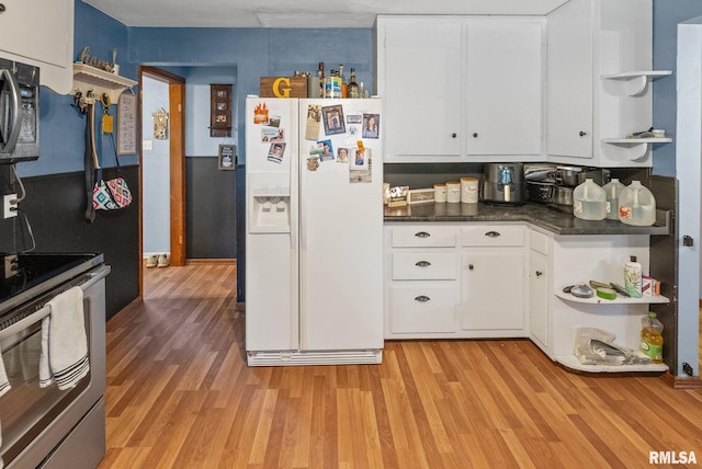 203 E 2nd St, Sparta, IL 62286 - kitchen featuring open shelves, white fridge with ice dispenser, light wood-type flooring, stainless steel range with electric stovetop, and white cabinetry