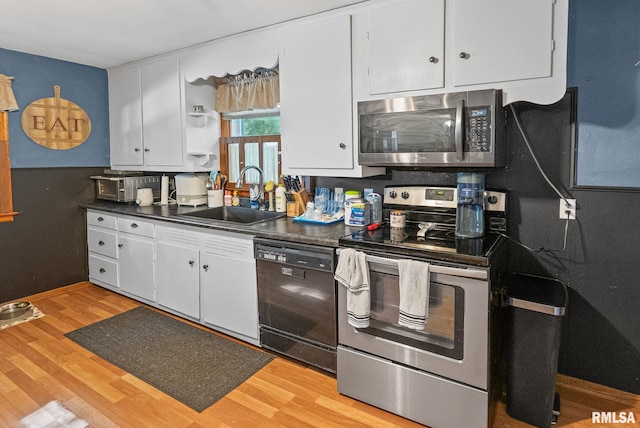 203 E 2nd St, Sparta, IL 62286 - kitchen with appliances with stainless steel finishes, a sink, dark countertops, open shelves, and white cabinets