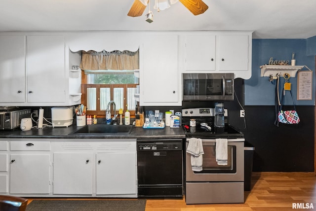 203 E 2nd St, Sparta, IL 62286 - kitchen with stainless steel appliances, a sink, white cabinets, and dark countertops