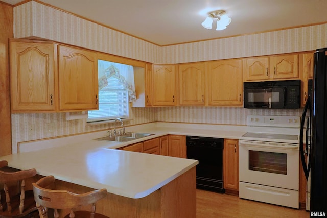914 Meadow Ln, Salem, IL 62881 - kitchen featuring black appliances, wallpapered walls, a sink, a peninsula, and light brown cabinets