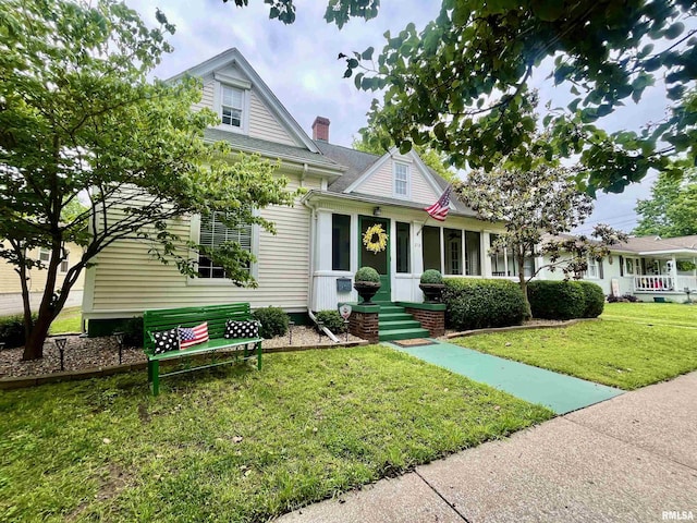 212 E 3rd St, Metropolis, IL 62960 - view of front of home with a front lawn, a chimney, and roof with shingles