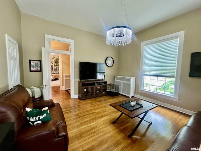 212 E 3rd St, Metropolis, IL 62960 - living area featuring a chandelier, wood finished floors, baseboards, and radiator