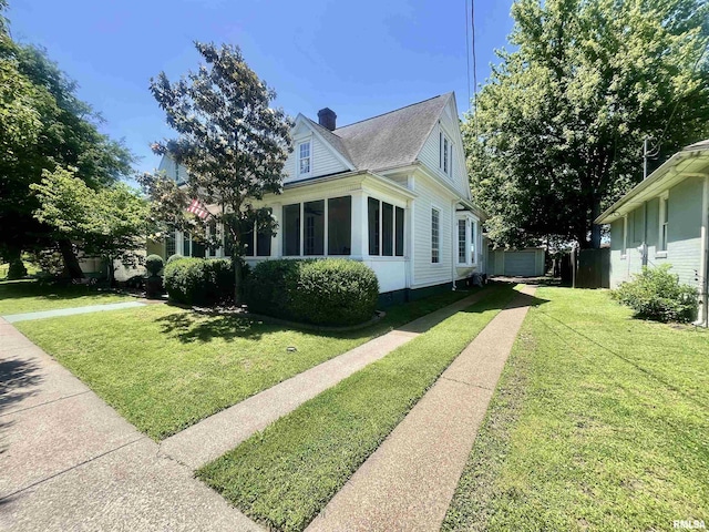 212 E 3rd St, Metropolis, IL 62960 - view of property exterior featuring a chimney, a lawn, driveway, and an outdoor structure