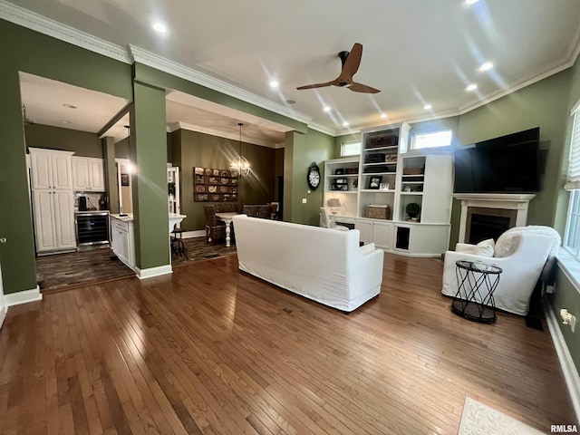 212 E 3rd St, Metropolis, IL 62960 - living area featuring ceiling fan, dark wood-style floors, a fireplace, ornamental molding, and baseboards