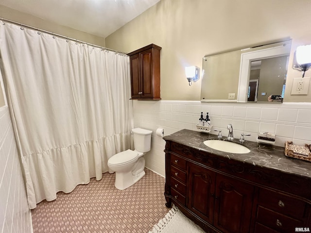212 E 3rd St, Metropolis, IL 62960 - bathroom with vanity, toilet, a wainscoted wall, tile walls, and tile patterned floors