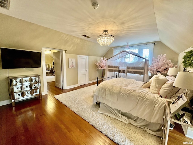 212 E 3rd St, Metropolis, IL 62960 - bedroom with wood finished floors, lofted ceiling, a chandelier, and baseboards