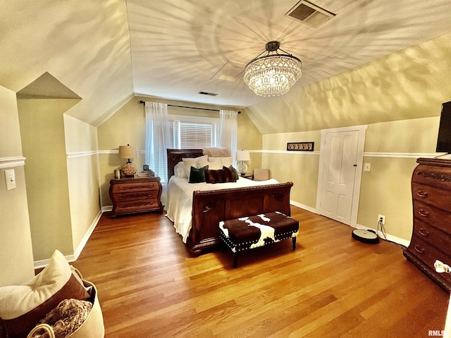 212 E 3rd St, Metropolis, IL 62960 - bedroom with wood finished floors, lofted ceiling, baseboards, and a chandelier