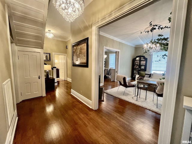 212 E 3rd St, Metropolis, IL 62960 - hallway with a chandelier, dark wood-style flooring, baseboards, and crown molding