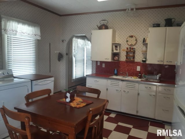 504 W Sylvester Ave, Christopher, IL 62822 - kitchen featuring ornamental molding, light flooring, a sink, washer / dryer, and white cabinets
