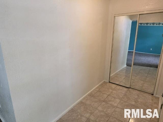 415 Marteeny St, Mount Vernon, IL 62864 - unfurnished bedroom with a closet, baseboards, and tile patterned flooring