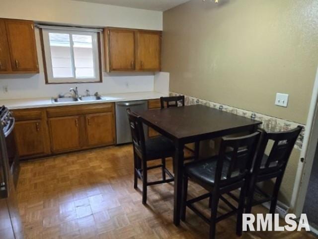 415 Marteeny St, Mount Vernon, IL 62864 - kitchen featuring dishwasher, a sink, brown cabinets, and light countertops