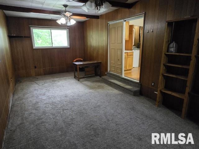 415 Marteeny St, Mount Vernon, IL 62864 - unfurnished bedroom featuring wooden walls, carpet floors, beamed ceiling, and ceiling fan
