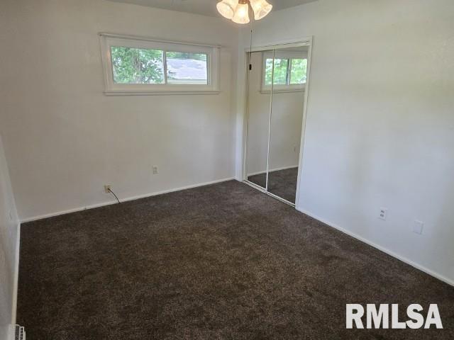 415 Marteeny St, Mount Vernon, IL 62864 - unfurnished bedroom with dark colored carpet, baseboards, and a closet
