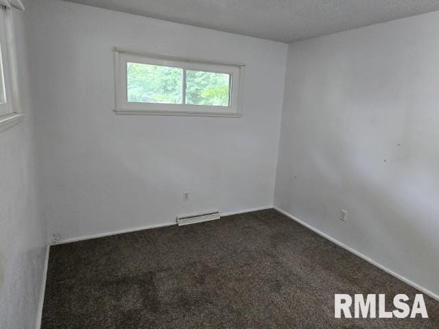 415 Marteeny St, Mount Vernon, IL 62864 - empty room featuring dark carpet and baseboards