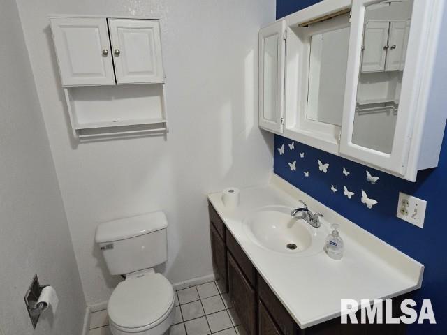 415 Marteeny St, Mount Vernon, IL 62864 - bathroom featuring vanity, toilet, tile patterned floors, and baseboards